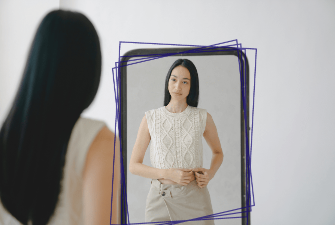 Woman trying on Job Interview Outfit in front of mirror