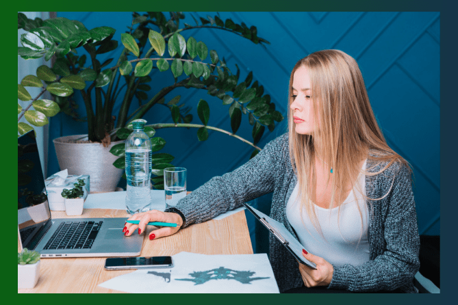 Woman working remotely on a computer in a blue room