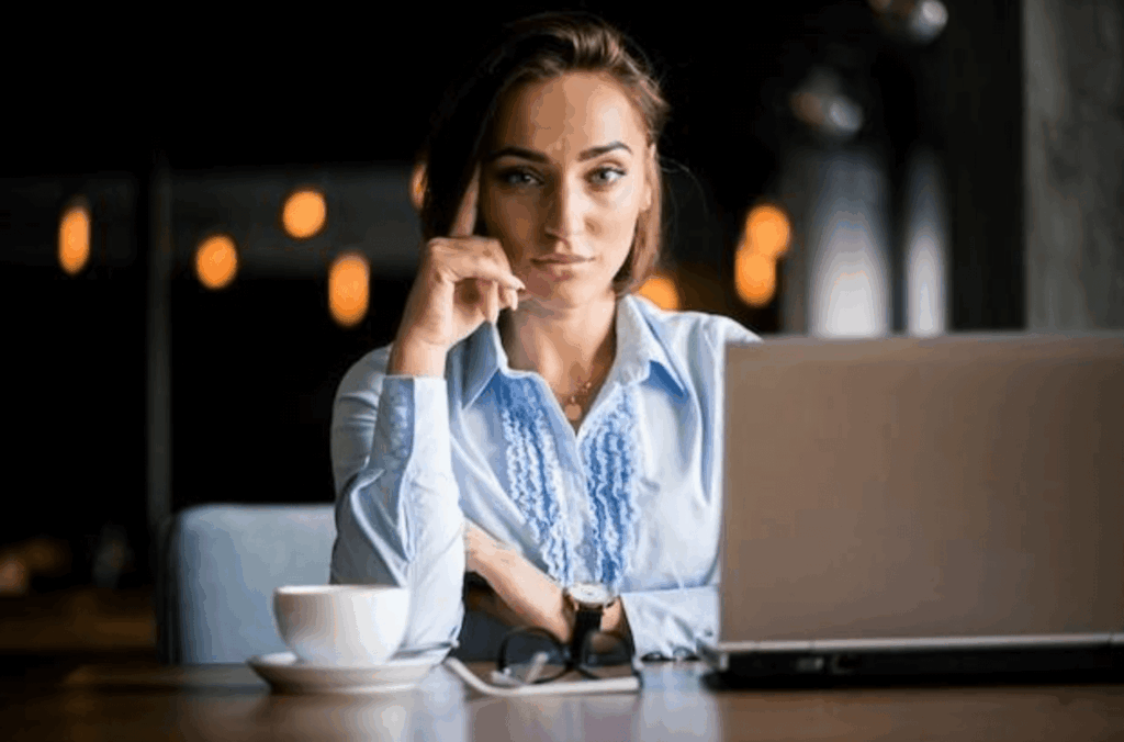 Female working on starting a business with her laptop and drinking coffee