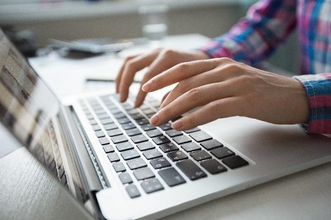 A laptop and hands