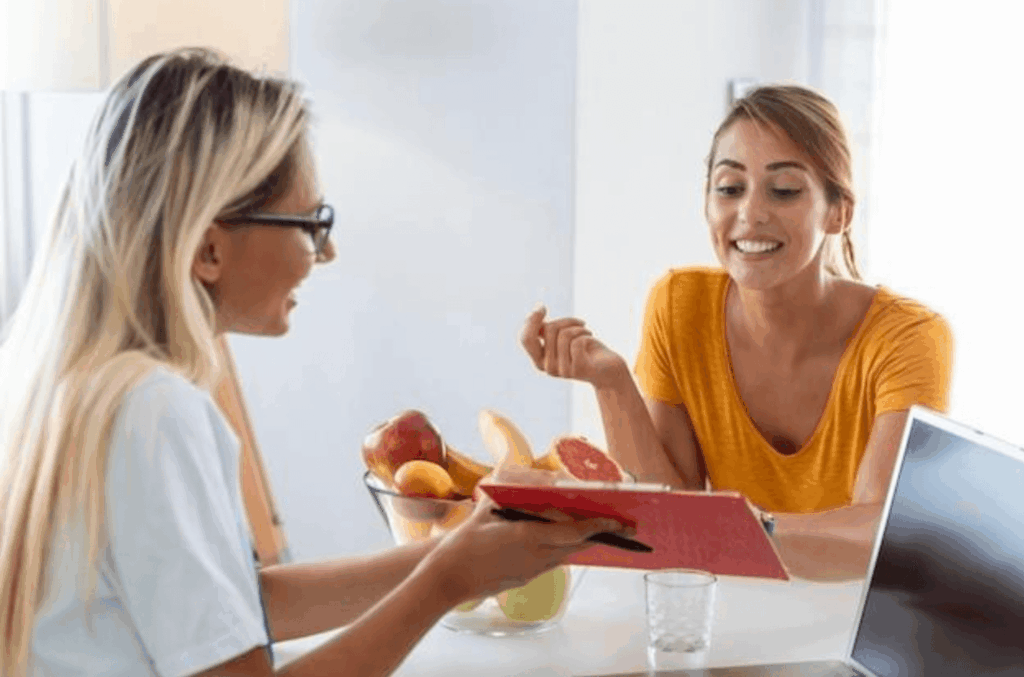 Females looking at chart how to become a nutritionist