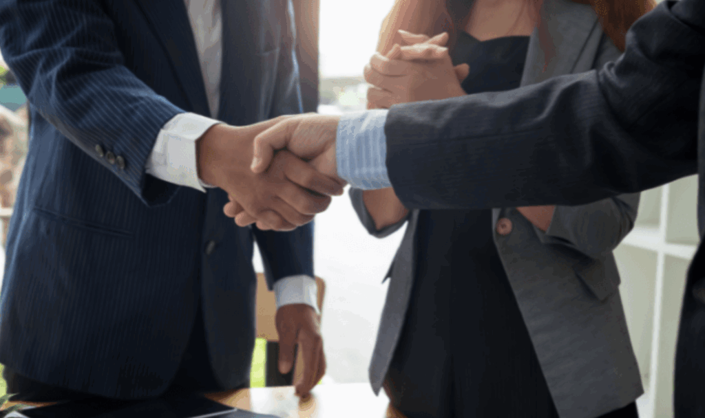 Two business people shaking hands after reaching agreement