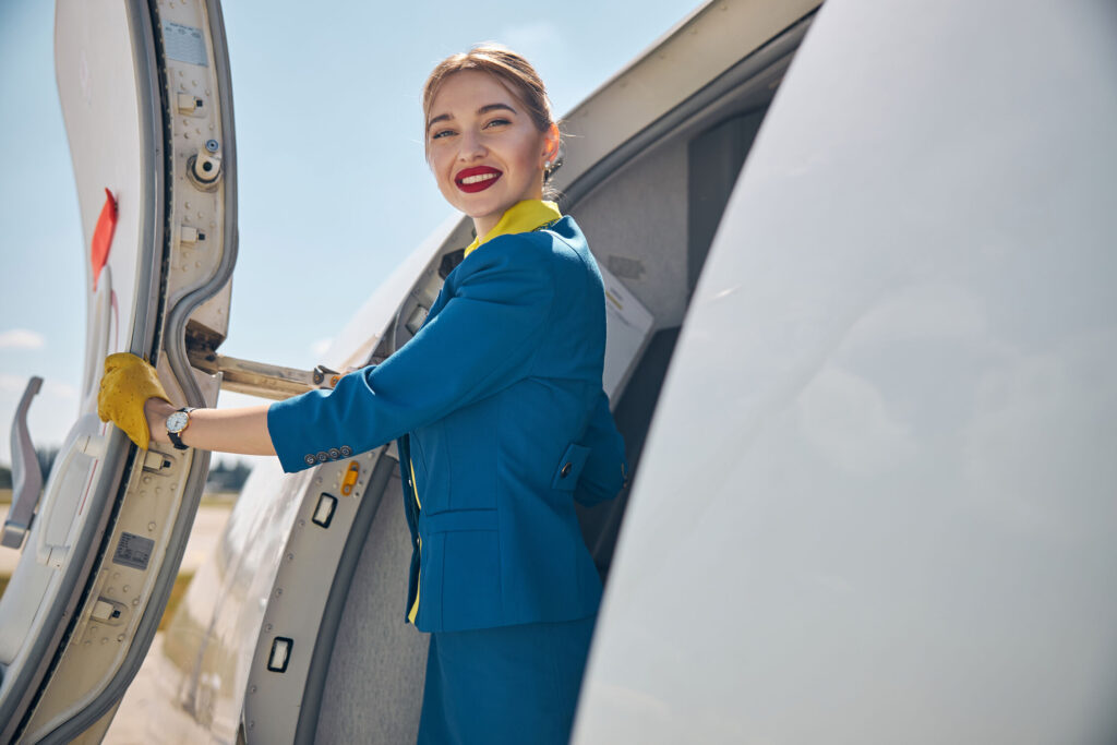 beautiful flight attendant standing near airplane 2024 10 18 09 33 21 utc optimized 1000