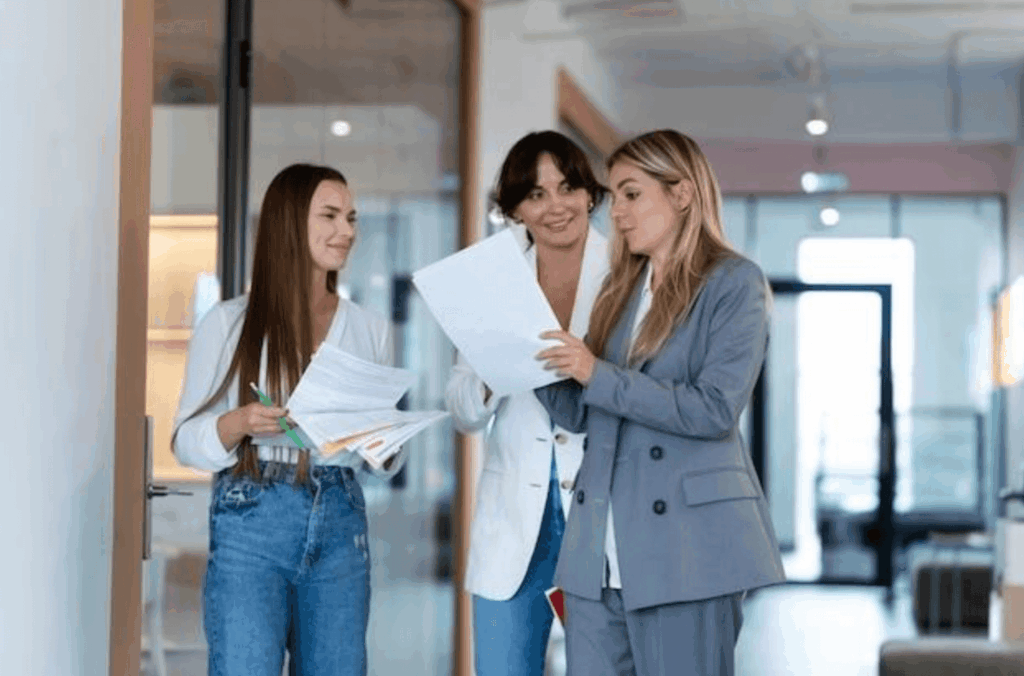 Females in an office talking about career development plans